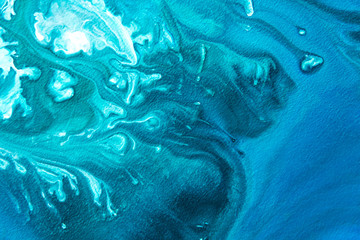 Abstract painting drawn by fluid acrylic technique. Picture with emerald, green, mint colorful water stains, gradients on blue background. Imitation of sea ocean waves on canvas. Modern art concept.