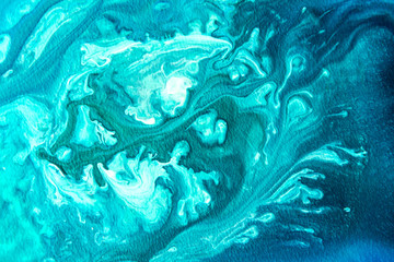 Abstract painting drawn by fluid acrylic technique. Picture with emerald, green, mint colorful water stains, gradients on blue background. Imitation of sea ocean waves on canvas. Modern art concept.