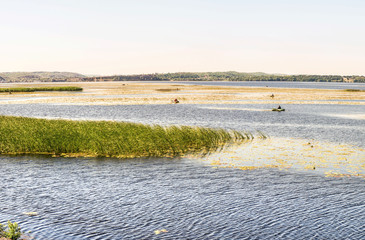 Morning fishing in the bay of the Dnieper on small boats, Kiev region, Ukraine.