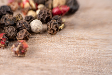 Peas, pepper mix, allspice close-up on wooden background