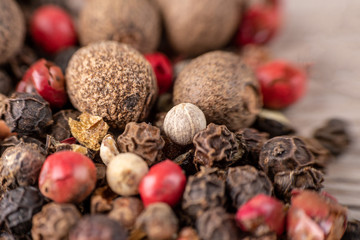 Peas, pepper mix, allspice close-up on wooden background