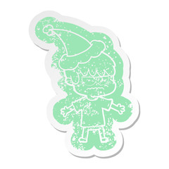 annoyed cartoon distressed sticker of a boy wearing santa hat