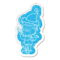 cartoon distressed sticker of a happy man wearing santa hat