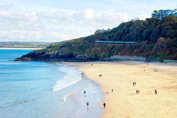 Winter sun, sandy beach, train arriving, Porthminster Beach, St Ives, Cornwall, England, UK.