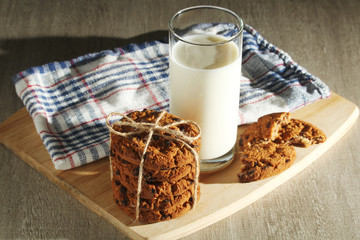 A glass with milk and chocolate cookies
