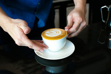 Closeup of hands with coffee cups in a cafe