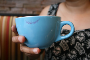 Mug of coffee with lipstick