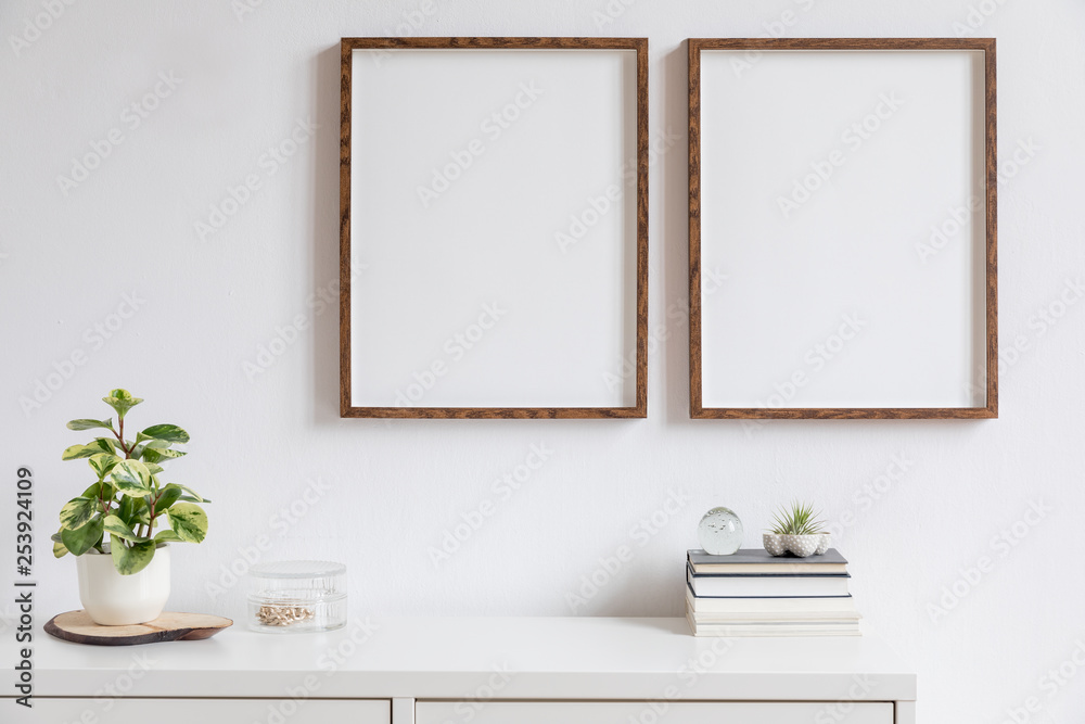 Wall mural minimalistic home decor of interior with two brown wooden mock up photo frames above the white shelf