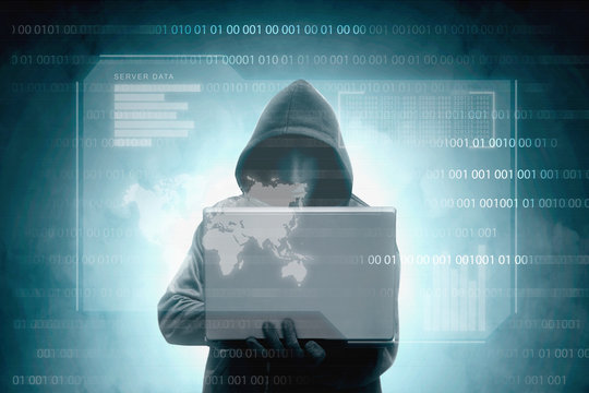 Hacker in black hoodie holding laptop with virtual display server data, chart bar, binary code and world map - Powered by Adobe