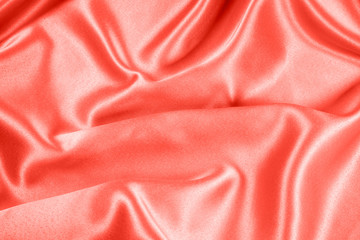 Closeup of rippled coral satin fabric