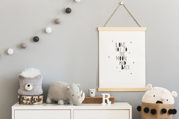 Stylish and cute scandinavian decor of child room with mock up poster, white shelf, natural toys,...