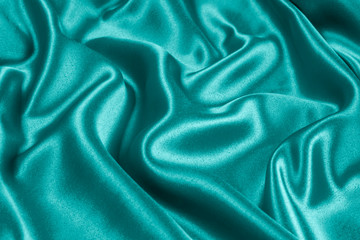 Fototapeta premium Closeup of rippled light blue satin fabric