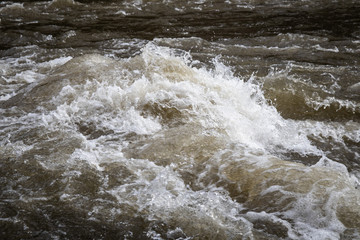 Turbulent water in river swollen due to snow melting