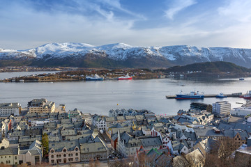 Fototapeta premium Alesund town and snowy mountains in Norway