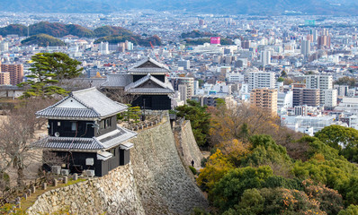 matsuyama castle wall with city in background in Ehime Japan