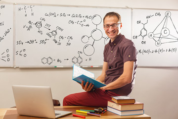 Portrait of confident Caucasian male teacher in classroom