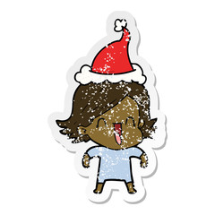 distressed sticker cartoon of a happy woman wearing santa hat