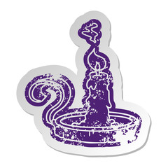 distressed old sticker of a candle holder and lit candle