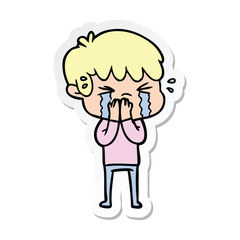 sticker of a cartoon boy crying