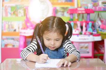 asian child cute or kid girl smiling writing or diligent review and enjoy doing mathematics homework or happy learning and training on white paper or book at nursery preschool or home and kindergarten