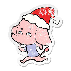 distressed sticker cartoon of a elephant remembering wearing santa hat