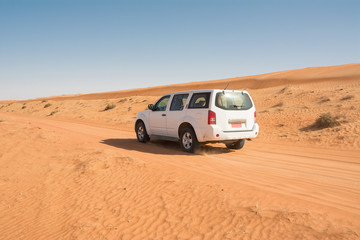 Fototapeta na wymiar Off-road vehicle on a track in the Wahiba Sand Desert (Oman)