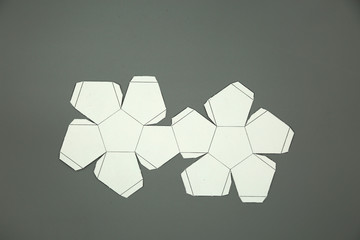 Geometry net of  platonic solids Dodecahedron. 2-dimensional shape that can be folded to form a 3-dimensional shape or a solid. Unfolded three Dimensional Figures. Isolated. Top view. 