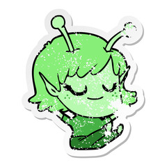 distressed sticker of a smiling alien girl cartoon sitting