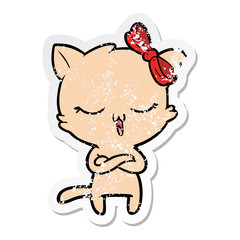 distressed sticker of a cartoon cat with bow on head