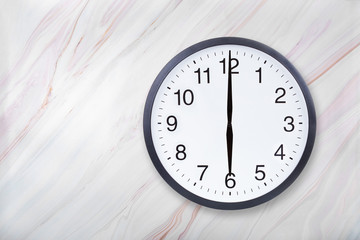 Wall clock show six o'clock on marble texture. Office clock show 6pm or 6am on marble texture with natural pattern