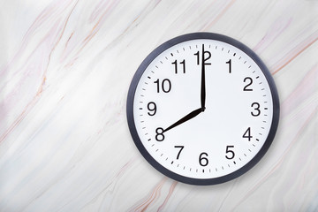 Wall clock show eight o'clock on marble texture. Office clock show 8pm or 8am on marble texture...