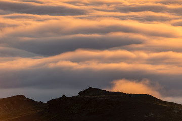  Dreamy misty landscape above the sea of clouds, mountains at sunset in Iceland