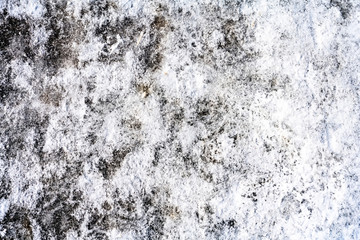 Background - icy snow on the road, mud, footprints, with texture, white, brown, sunny day. Suitable for design.