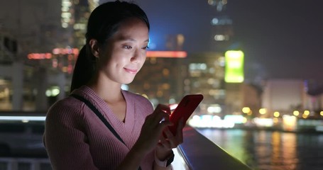Woman use of mobile phone at night