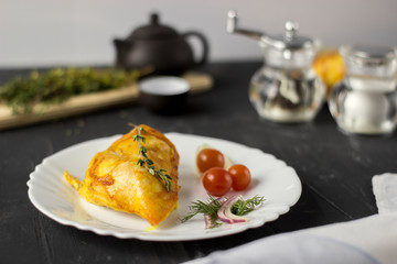 Baked chicken breast with onions and tomatoes on a white plate. Healthy food.