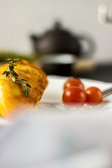 Baked chicken breast with onions and tomatoes on a white plate. Healthy food.
