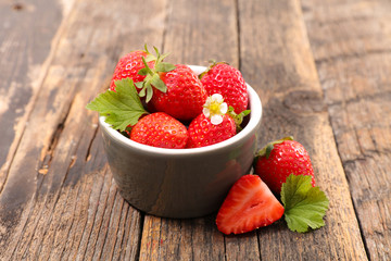 strawberry and leaf on wood background