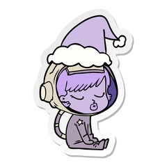sticker cartoon of a pretty astronaut girl sitting waiting wearing santa hat
