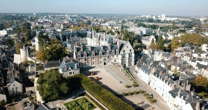 View from drone of impressive Royal Chateau de Blois on background with cityscape in sunny autumn day, France