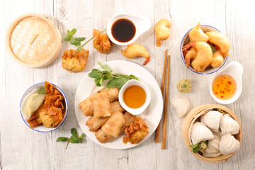different sort of asian food with shrimp, spring roll, dumpling and soy sauce