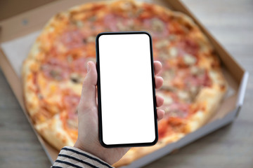 holding phone with isolated screen above pizza box