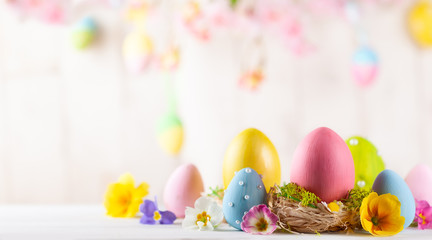 Easter composition with colorful Easter eggs  and spring flowers.
