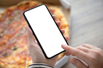 female hands holding phone with isolated screen above pizza box
