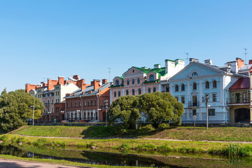 Fototapeta na wymiar The Golden Embankment on the Velikaya River on a sunny summer day. Pskov. Russia