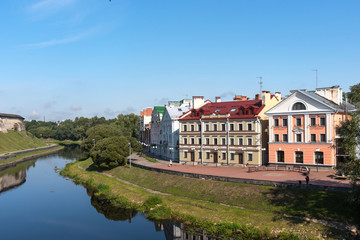 Fototapeta na wymiar The Golden Embankment on the Velikaya River on a sunny summer day. Pskov. Russia