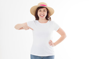 Summer t shirt design and people concept close up of woman in blank template white t-shirt and beach hat point on copy space on white tshirt. Mock up. Front view.