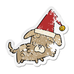 distressed sticker of a cartoon dog in christmas hat
