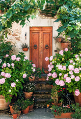 door with flower Pienza town, world UNESCO heritage, Europe, Italy, Tuscany