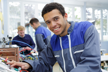 portrait of young technician at controls of machine
