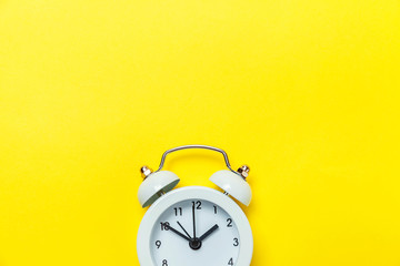 Ringing twin bell vintage classic alarm clock Isolated on yellow colourful trendy modern...